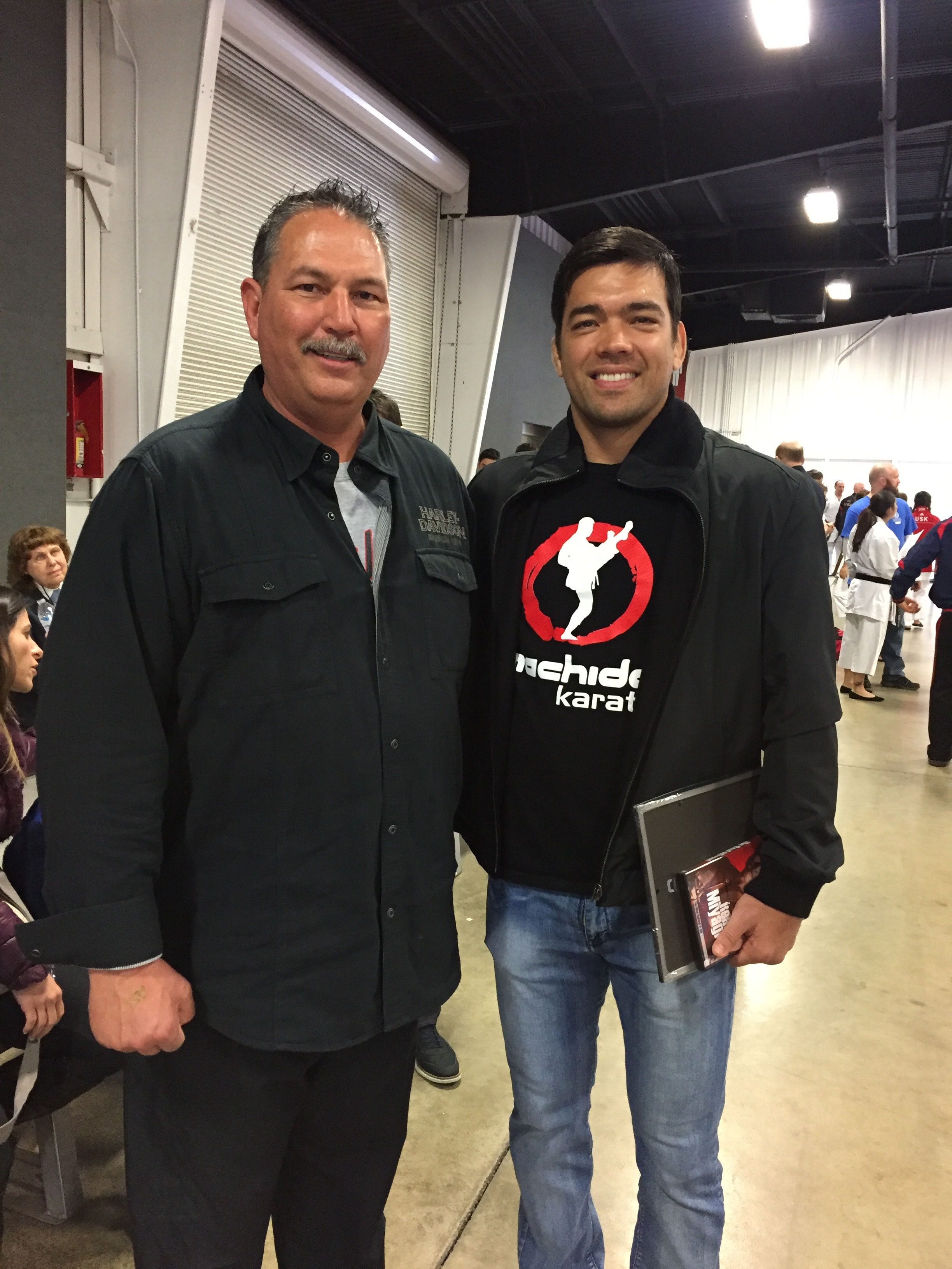 Two men at Uchida Karate event, man in black jacket and instructor